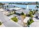 A waterfront home with a driveway and landscaping at 203 Bath Club N Blvd, North Redington Beach, FL 33708