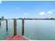 An inviting waterfront canal view offers a dock for boating and serene water views at 203 Bath Club N Blvd, North Redington Beach, FL 33708