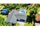 Backyard aerial view of home showing screened pool, shed, and surrounding trees at 210 Lake Hobbs Rd, Lutz, FL 33548