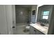 Bathroom boasts updated vanity, marble-look tiling, and shower/tub combination at 210 Lake Hobbs Rd, Lutz, FL 33548