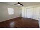 Comfortable bedroom with hardwood floors, closet space, and natural light at 210 Lake Hobbs Rd, Lutz, FL 33548