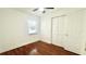 Bright bedroom with hardwood floors, ceiling fan, and large closet offers cozy comfort at 210 Lake Hobbs Rd, Lutz, FL 33548