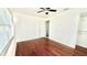 This bright bedroom has a ceiling fan, beautiful wood floors, and a walk-in closet at 210 Lake Hobbs Rd, Lutz, FL 33548