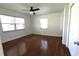 Bedroom featuring hardwood floors, natural light, and a ceiling fan at 210 Lake Hobbs Rd, Lutz, FL 33548