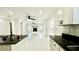 Open kitchen view with granite counters, stainless appliances, and seamless living room access at 210 Lake Hobbs Rd, Lutz, FL 33548