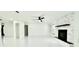 Spacious living room with sleek floors, modern fireplace, and recessed lighting at 210 Lake Hobbs Rd, Lutz, FL 33548
