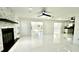 Open-concept living room featuring a stone fireplace and seamless access to the kitchen at 210 Lake Hobbs Rd, Lutz, FL 33548