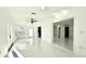 Bright open living room with sleek tile floors and access to outdoor spaces at 210 Lake Hobbs Rd, Lutz, FL 33548