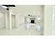 Bright living room featuring a stone fireplace, ceiling fan, and sleek tile floors at 210 Lake Hobbs Rd, Lutz, FL 33548
