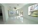 Bright living area featuring sleek flooring and direct access to outdoor patio at 210 Lake Hobbs Rd, Lutz, FL 33548