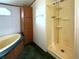 Bathroom featuring walk-in shower, tub, and vanity for storage at 215 S Port Royal Ln, Apollo Beach, FL 33572
