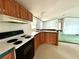 Kitchen featuring wood cabinets, white countertops and black appliances at 215 S Port Royal Ln, Apollo Beach, FL 33572