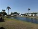 Picturesque community pond with a fountain surrounded by lush greenery and palm trees at 215 S Port Royal Ln, Apollo Beach, FL 33572