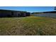 A spacious backyard with healthy green grass and a privacy fence offers plenty of room at 21838 Edgewater Dr, Port Charlotte, FL 33952