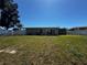 Home featuring a large backyard with lush grass and a white privacy fence at 21838 Edgewater Dr, Port Charlotte, FL 33952