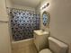 Bright bathroom featuring a shower with a black and white curtain and a neutral toned vanity and mirror at 21838 Edgewater Dr, Port Charlotte, FL 33952