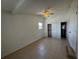 This bedroom features an ensuite bathroom and sliding closet doors, as well as tile floors at 21838 Edgewater Dr, Port Charlotte, FL 33952