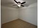 Cozy bedroom with a ceiling fan and tiled floors, providing a comfortable space at 21838 Edgewater Dr, Port Charlotte, FL 33952