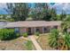 Tan house with walkway and well-manicured lawn at 21838 Edgewater Dr, Port Charlotte, FL 33952