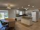 Eat-in kitchen with tile floors, granite counters, island, and stainless steel appliances at 21838 Edgewater Dr, Port Charlotte, FL 33952