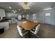 Open-concept kitchen and dining area featuring a large island, white appliances, and modern lighting at 21838 Edgewater Dr, Port Charlotte, FL 33952