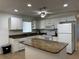 Bright eat-in kitchen with tile floors, granite counters, island, and stainless steel appliances at 21838 Edgewater Dr, Port Charlotte, FL 33952