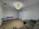 This living room features tile floors, modern lighting, and a gray sectional with a desk nearby at 21838 Edgewater Dr, Port Charlotte, FL 33952