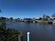 Serene waterfront view showcasing multiple boat docks and waterfront homes at 21838 Edgewater Dr, Port Charlotte, FL 33952