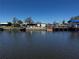 Waterfront view featuring multiple boat docks on a sunny day at 21838 Edgewater Dr, Port Charlotte, FL 33952