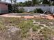 Backyard featuring an empty pool, lounge chairs, and a white fence at 2452 Baywood E Dr, Dunedin, FL 34698