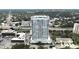 Stunning aerial view of modern high-rise condo building with pool, overlooking the city and a lush tree canopy at 2910 W Barcelona St # 403, Tampa, FL 33629