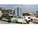 Aerial view of high-rise condominium with water views, featuring a rooftop amenity deck, and surrounding buildings at 2910 W Barcelona St # 403, Tampa, FL 33629