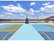 Modern basketball court featuring vibrant color blocks and a clear view of the basketball hoop and surroundings against a bright, cloudy sky at 2910 W Barcelona St # 403, Tampa, FL 33629