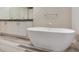 Modern bathroom featuring a soaking tub, double vanity with elegant fixtures, and stylish floor tiles at 2910 W Barcelona St # 403, Tampa, FL 33629