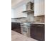 Bright kitchen with tiled floors, gas range, stainless hood, and modern fixtures at 2910 W Barcelona St # 403, Tampa, FL 33629