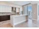 Bright kitchen with a large center island, modern appliances, and sliding glass doors to an outdoor area at 2910 W Barcelona St # 403, Tampa, FL 33629
