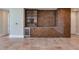 Living room with a modern storage unit, a built-in wine cooler, and tiled floors at 2910 W Barcelona St # 403, Tampa, FL 33629