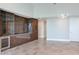 Bright living room with wine cooler and storage, tiled floors, and modern light fixture at 2910 W Barcelona St # 403, Tampa, FL 33629