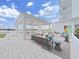 Upscale outdoor lounge area with covered seating, an outdoor kitchen, and a manicured lawn at 2910 W Barcelona St # 403, Tampa, FL 33629