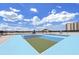 Bright pickleball court with colorful surface and new nets, set against a blue sky and with partial views of the city in the background at 2910 W Barcelona St # 403, Tampa, FL 33629