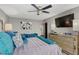 Bedroom features a blue sofa, decor mirror, and TV above the dresser at 3301 Bayshore Blvd # 2108B, Tampa, FL 33629