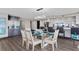 Dining room with a glass table, seating for six, modern lighting and views into the kitchen at 3301 Bayshore Blvd # 2108B, Tampa, FL 33629