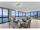 Dining room with a glass table, seating for six, modern lighting and water views at 3301 Bayshore Blvd # 2108B, Tampa, FL 33629