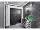 Elegant entryway featuring stylish black double doors, a mirrored dresser and patterned wallpaper at 3301 Bayshore Blvd # 2108B, Tampa, FL 33629