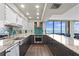 Modern kitchen with stainless appliances, granite countertops, grey cabinets, blue tile backsplash, and large window views at 3301 Bayshore Blvd # 2108B, Tampa, FL 33629