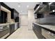Contemporary kitchen featuring granite countertops, stainless steel appliances, and sleek dark cabinetry at 3301 Bayshore Blvd # 2108B, Tampa, FL 33629