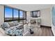 Cozy living room boasts a mirrored console, TV, and large windows with scenic views at 3301 Bayshore Blvd # 2108B, Tampa, FL 33629
