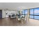 Living room with a glass table, seating for six, modern lighting and views into the kitchen and water at 3301 Bayshore Blvd # 2108B, Tampa, FL 33629