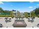 Community outdoor lounge with seating around a fire pit and BBQ grills at 3301 Bayshore Blvd # 2108B, Tampa, FL 33629