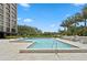 Community pool with lounge chairs and beautifully landscaped surroundings at 3301 Bayshore Blvd # 2108B, Tampa, FL 33629